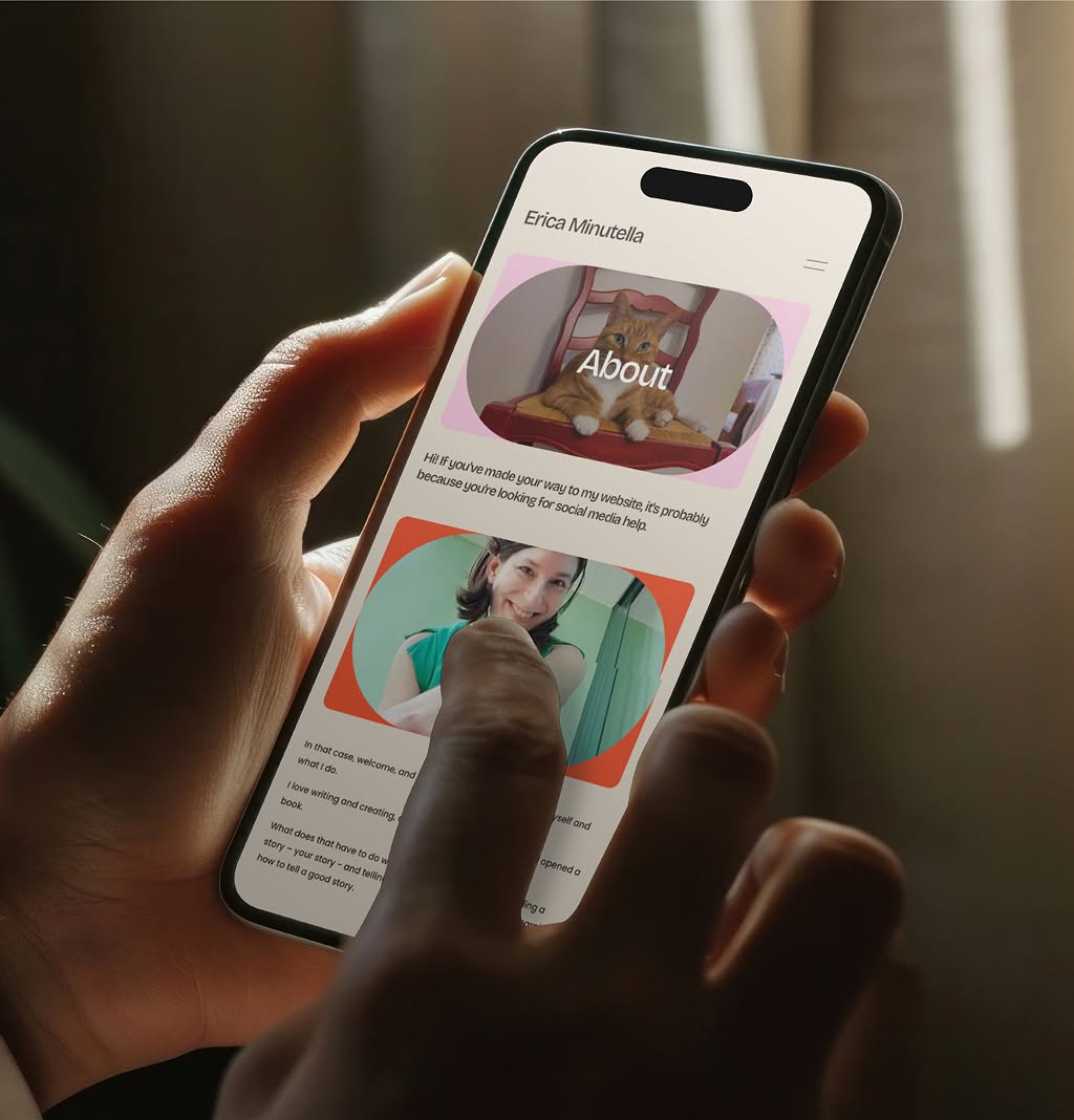 EricaMinutella-AboutMobile Person holding a smartphone displaying the Erica Minutella website with a cat and a woman. The screen text includes “Erica Minutella” and “About.”