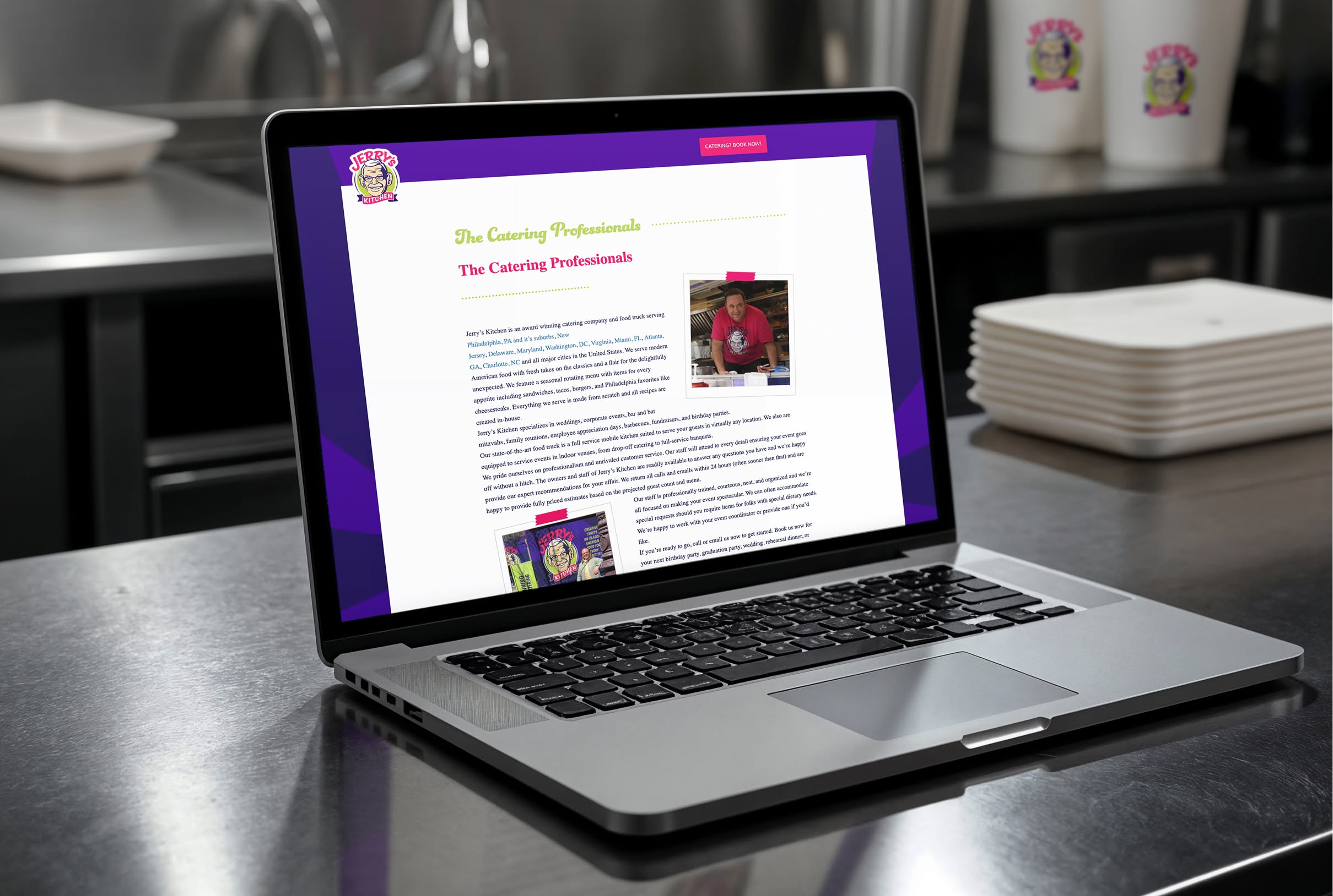 Laptop on a stainless steel counter displaying a colorful page from the Jerry's Kitchen website titled "The Catering Professionals." Plates and branded cups are in the background.