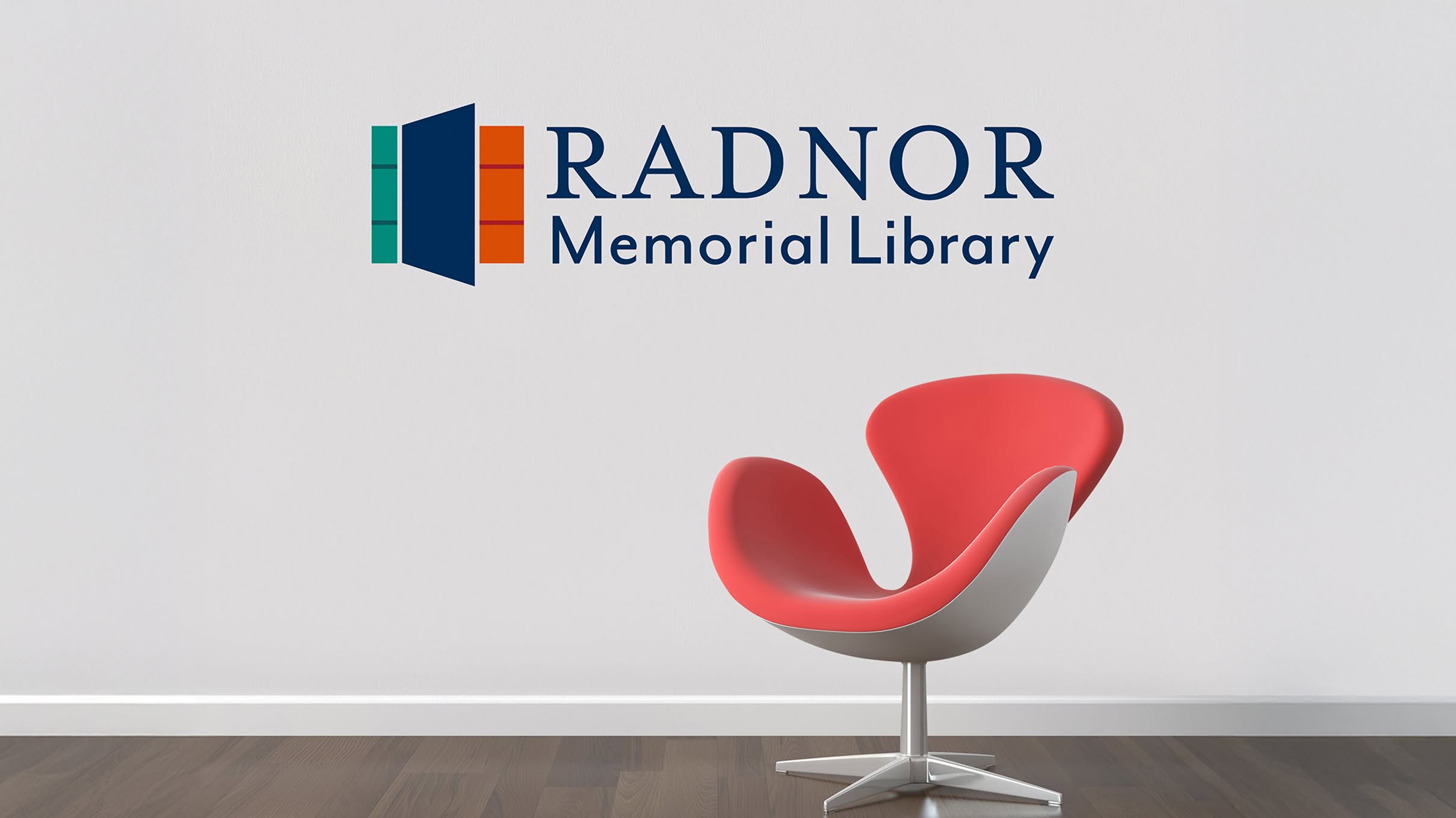 RML-Hero Modern red chair on wooden floor against white wall with the Radnor Memorial Library logo. The logo includes a green, navy, and orange rectangles.