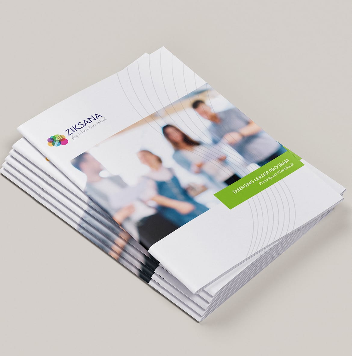 Ziksana-BookletFront A stack of Ziksana workshop brochures titled "Emerging Leader Program" features a blurred image of four people interacting. The Ziksana logo appears at the top.